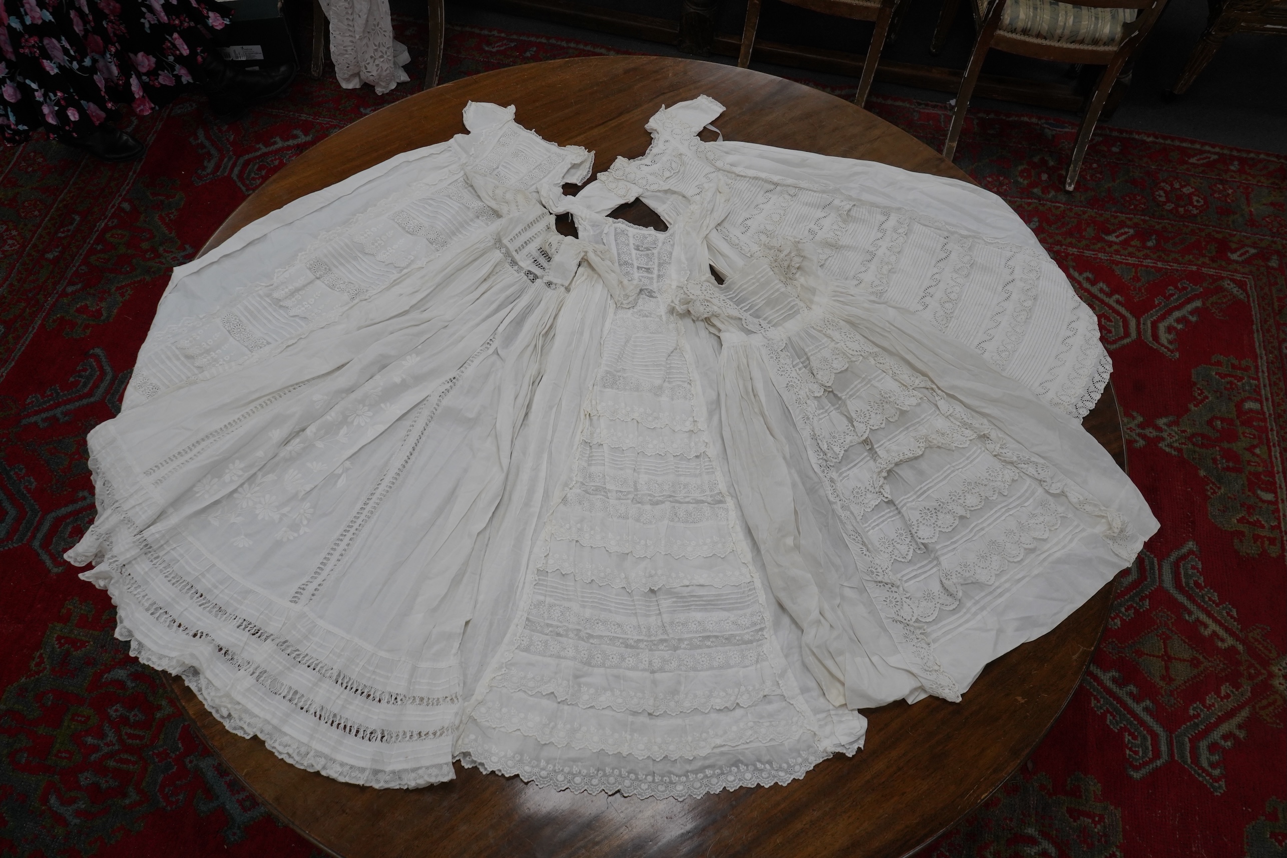 Five Victorian white worked fine cotton and lawn baby’s christening gowns. mostly worked with embroidery anglaise, feather stitching, tucking, drawn thread work and lace edging, longest 41cm. Condition - in good conditio